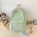Zaino minimalista verde menta in tela con grazioso ricamo a cuore per uso scolastico. - 30x13x40cm / Verde