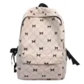 Zaino chic in velluto a coste beige con fiocchi neri e motivo trapuntato per studenti e tempo libero. - Bianco