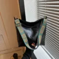 Black leather hobo bucket bag with wide colorful ethnic strap, chic casual crossbody. - Black