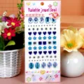 Blue acrylic rhinestone sticker sheet featuring mixed star heart plum shapes. Detail view. - Plum Blossom / Blue