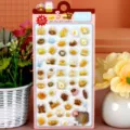 Close-up details of 3D embossed cute cartoon animal and food stickers on card display. - Bear Food