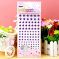 Detail shot of purple acrylic star rhinestone crystal stickers with card backing for craft and party decor. - Five-Pointed Star Purple