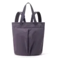 Close-up detail of the purple waterproof nylon tote backpack, showing durable straps and pockets. - Taro Ball Grape