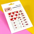 Gros plan détaillé d'autocollants de visage en strass avec des fleurs rouges et gemmes. - Petites fleurs rouge