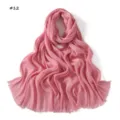 Pink pleated scarf detail showcasing delicate texture, lightweight breathable fabric and fringed edges. - Pink