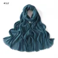 Detailed view of dark blue pleated fringed women scarf, elegant texture and soft fabric. - Blue