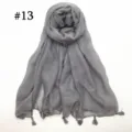Close-up view of the lightweight gray voile scarf showing fine tassel hem and texture. - Gray