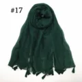 Green voile scarf detail showcasing tassel fringe, lightweight texture and fine weave. - Dark Green
