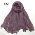 Detail view of a lightweight solid color voile scarf featuring delicate hanging tassels. Perfect - Light Khaki