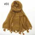 Detailed shot of lightweight solid mustard yellow voile scarf with delicate tassel fringe. - Mustard Yellow