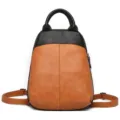 Leather two-tone backpack detail showing contrast color texture and top handle. - Yellow