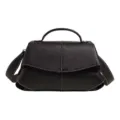 Detailed view of black leather shoulder bag with top handle and contrast white stitching. - Black