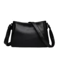 Black leather shoulder bag detail, minimalist design, premium texture, daily crossbody wear. - Black