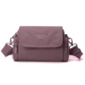 Casual women's minimalist solid color crossbody bag with adjustable strap and side zipper pockets. - Pink