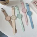 Detailed flat lay view of colorful macaron silicone quartz student watches on a clean white surface. - Brown