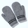 Detail view of grey knit mittens with black stripes, winter warm fuzzy gloves close up. - Big Kids / Light Gray