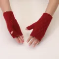 Close up of red knit fingerless gloves showing the warm textured winter wool fabric design. - One Size / Burgundy