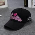 Close-up detail of the black baseball cap featuring pink glitter embroidered Sweetie text and heart. - Black