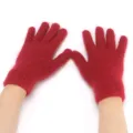 Detailed shot of soft red fuzzy knitted gloves showing fine wool texture and warm cuff. - Burgundy