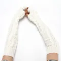 Detailed shot of white cable knit arm warmers, cozy long fingerless gloves winter style. - One Size / White