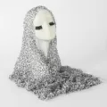 Close-up detail of the black and white leopard print bubble crinkle scarf on display. - White Leopard