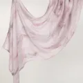 Detailed shot of a lightweight pink rayon long scarf featuring elegant abstract marble print draping. - YW485-01