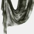 Close-up detail of women's tie-dye crinkle scarf, lightweight green draped shawl fabric. - Green