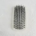 Detail view of oval beard brush with soft black bristles and rounded tips for men's styling. - Square Style (H9419)