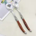Stainless steel salad serving spoon and fork set with elegant wood grain handle for dining. - 2-Piece Wood Grain Plastic Handle Set / Wood Grain