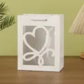Close up of a white paper gift bag with clear window and heart cutout, elegant packaging. - 18x10x23cm / White