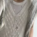 Detail shot of a long stainless steel sweater chain featuring a hammered heart pendant and white bead accents. - Silver Heart + White Handmade Chain