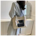 Woven straw tote bag detail showing black pocket with summer print and cute decorative scarf. - Black