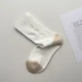 White mid-calf socks featuring contrast beige heel and toe with subtle bird jacquard design. - One Size / Cream White