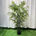 Artificial bamboo plant detail view, showing realistic green leaves and sturdy stalks. - 130cm