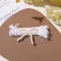 Handmade faux pearl fabric bow accessory, white fringe design, perfect for DIY crafts. - White