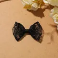 Black lace bow detail close up showing intricate mesh texture and center satin ribbon wrap. - Style 2 Bowknot / Black
