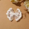 Close-up detail of a delicate white lace bow accessory, perfect for DIY crafts and fashion. - Style 1 Bowknot / White
