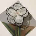 Close-up detail of 3D mesh flower accessory with black trim and rhinestone center for DIY crafts. - Apricot