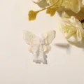 Close-up detail of the mesh butterfly patch with delicate beading and floral tassel charms. - Yellow
