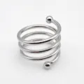 Détail de rond de serviette en spirale métallique argentée, design ressort moderne. - Argent