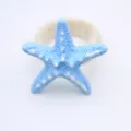 Blue resin starfish napkin ring detail close up view table decor modern minimalist style - Blue Starfish