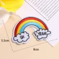 Detailed close-up shot of colorful rainbow and cloud embroidered cloth patch accessory. - Style 1