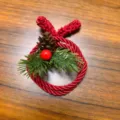Close-up view of the handmade red twisted rope Christmas wreath with pinecone and berry decor. - Single / Red