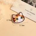 Close-up detail shot of a cute cartoon cat embroidered patch, perfect for DIY clothing decor. - Style 6