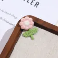 Close up detail view of cute pink and green fabric flower embroidery patch clothing accessory - Style 6