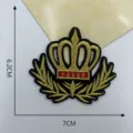 Detailed close-up of a golden crown embroidery patch with laurel wreath, measuring 6.2x7cm. - Style 5