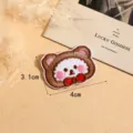 Cute cartoon bear embroidered patch DIY clothing accessory with pink blush and red bow design. - Style 7