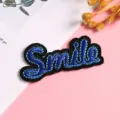 Detailed close-up view of the blue and black embroidered Smile patch for DIY clothes decor. - Style 8 (Smile)