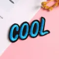 Detail shot of the COOL embroidered patch, blue thread on black fabric, DIY garment accessory. - Style 9 (COOL)