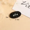 Black oval lace embroidered clothing patch with allo text, perfect for DIY garment decoration. - Oval / Black